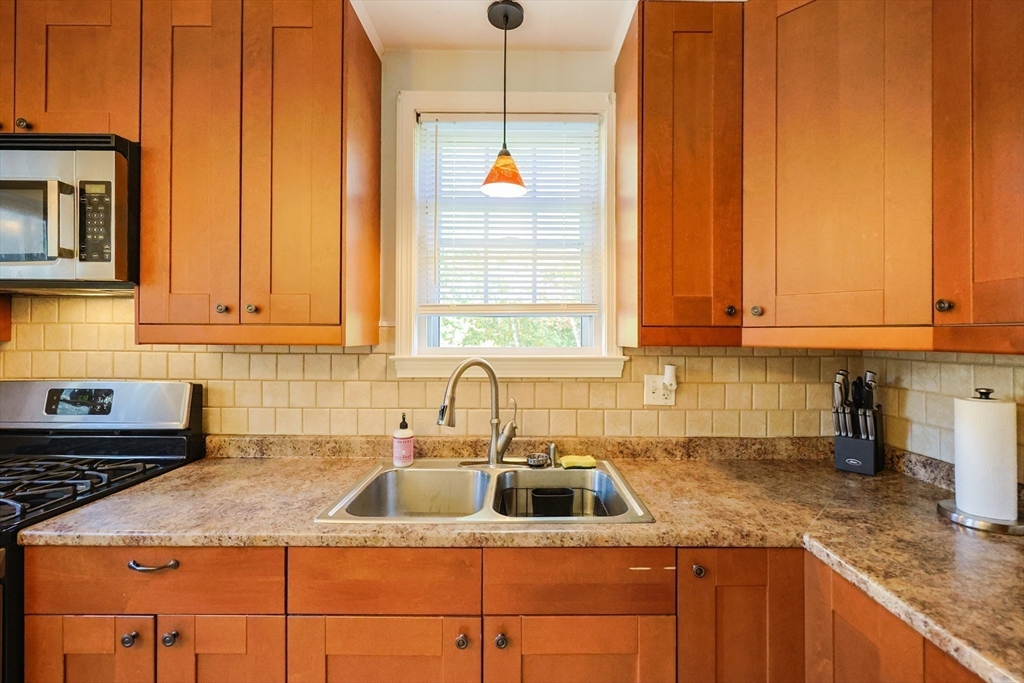 12 Randall Street Acushnet, MA 02743 - Photo 6 of 20 a kitchen with stainless steel appliances granite countertop a sink a stove and cabinets