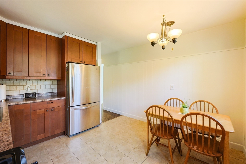 12 Randall Street Acushnet, MA 02743 - Photo 8 of 20 a kitchen with stainless steel appliances granite countertop a dining table and chairs