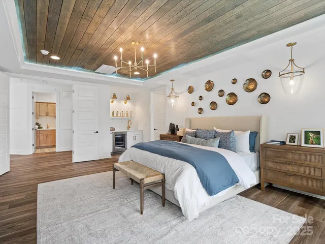 a bedroom with bed and a chandelier