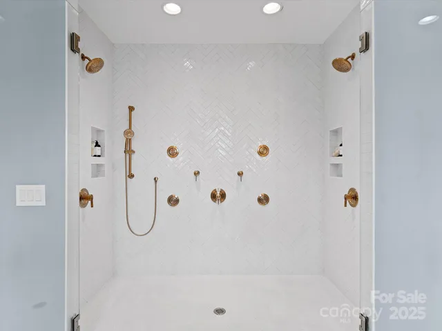 a bathroom with a bathtub sink and mirror