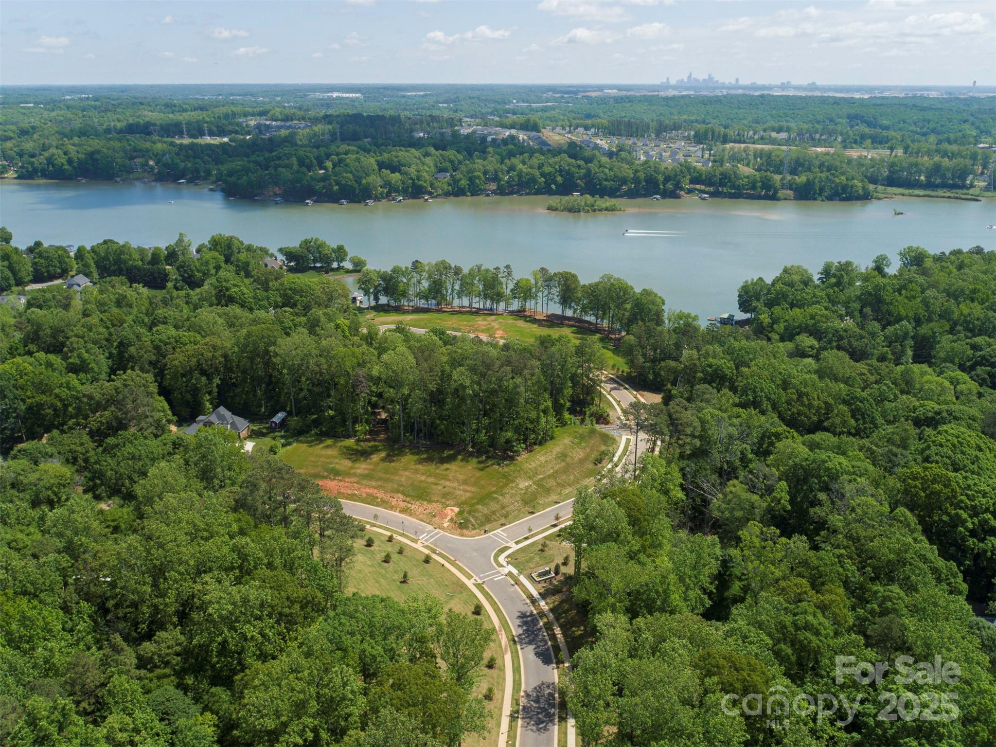 42 Watercourse Way, Unit DEVONSHIRE Belmont, NC 28012 - Photo 47 of 48 an aerial view of residential houses with outdoor space and lake view