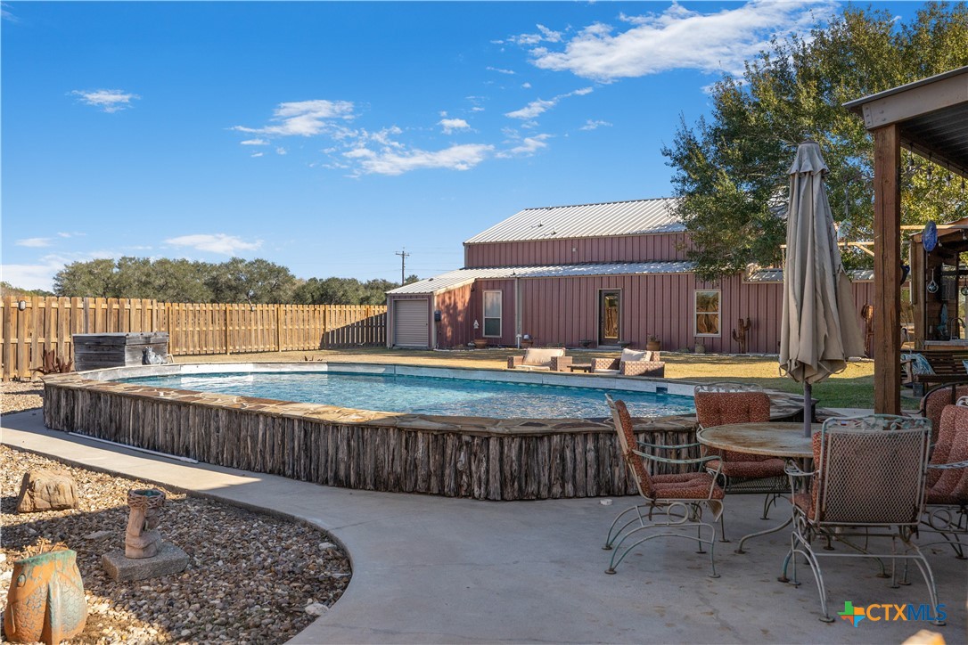 2796 Benbow Road Inez, TX 77968 - Photo 32 of 35 a view of a swimming pool with a lounge chairs on the terrace