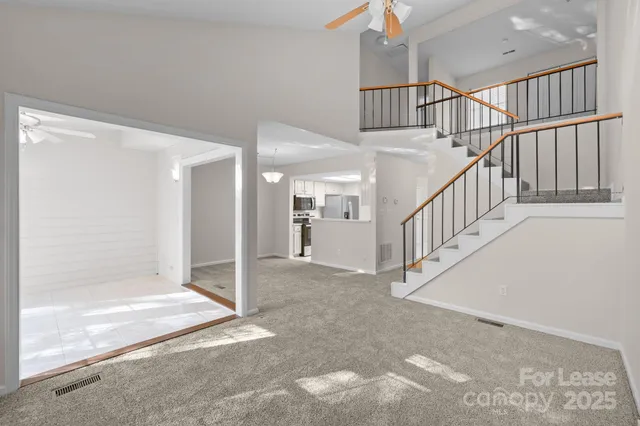 an empty room with windows and fireplace