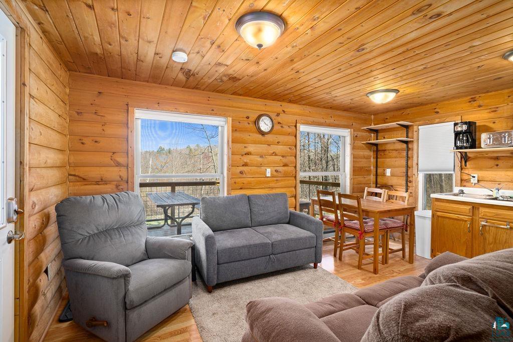 20663 Hardwood Loop Finlayson, MN 55735 - Photo 16 of 36 Wood-paneled interior featuring log cabin style walls and ceiling