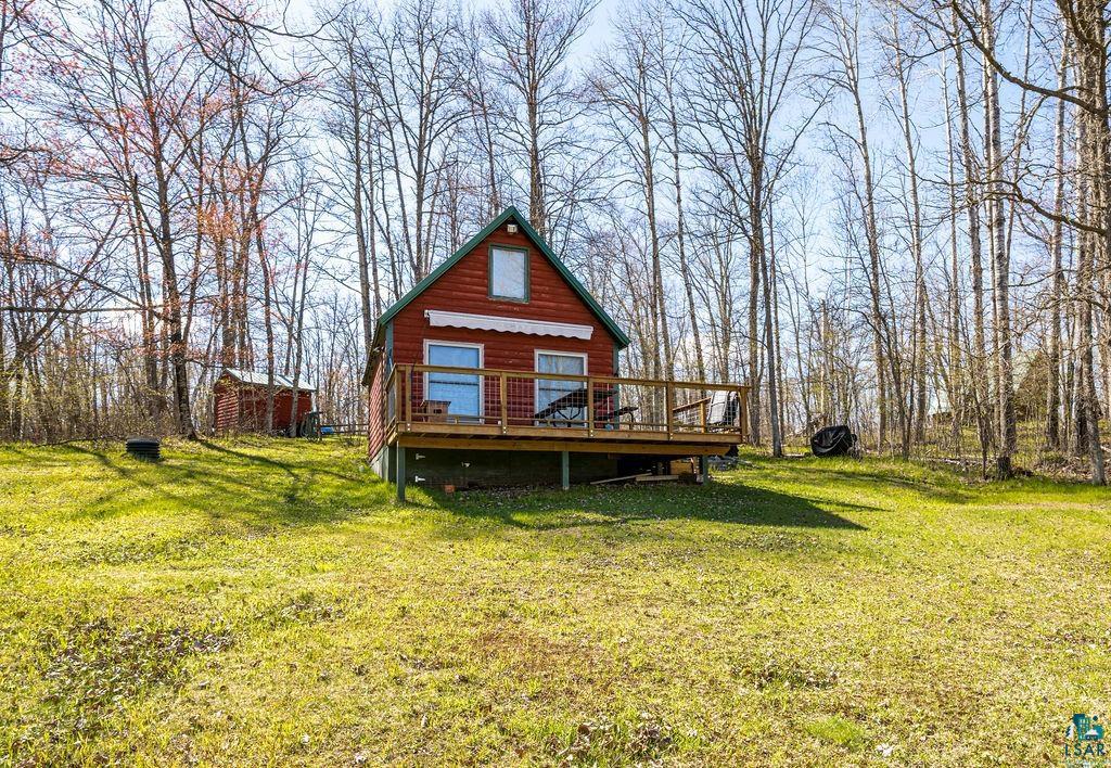 20663 Hardwood Loop Finlayson, MN 55735 - Photo 2 of 36 Red siding cabin featuring a prominent wooden deck with railing, a white awning, and a gabled roof