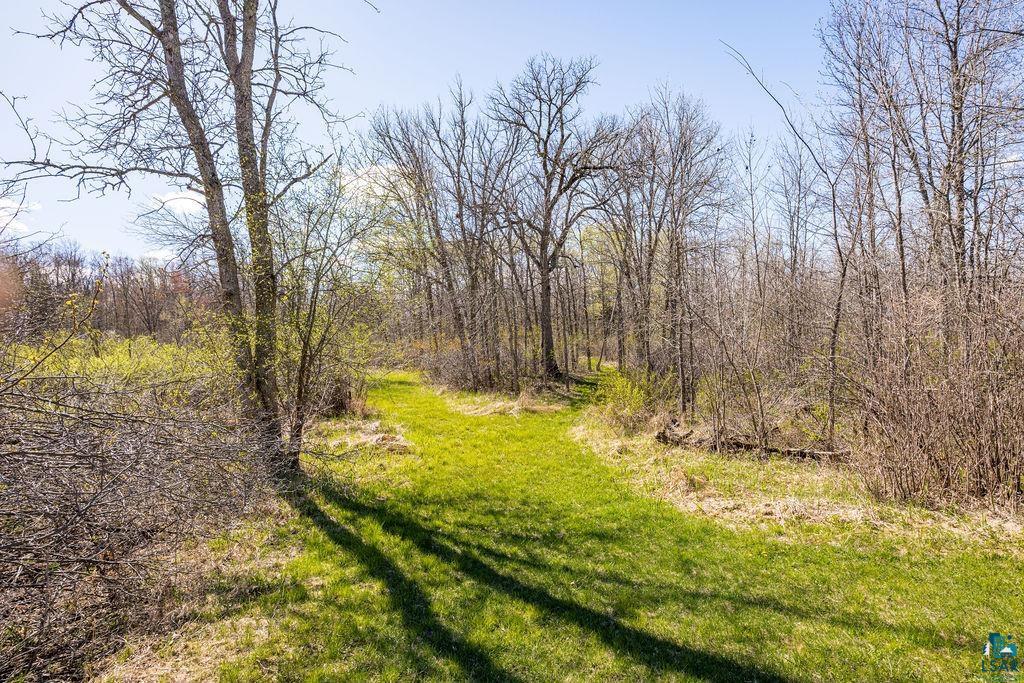 20663 Hardwood Loop Finlayson, MN 55735 - Photo 25 of 36 Manicured grassy path through a wooded area with mature trees and varied undergrowth