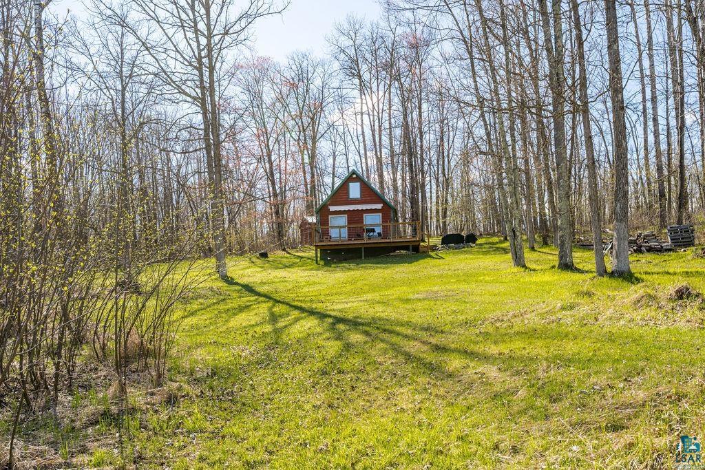 20663 Hardwood Loop Finlayson, MN 55735 - Photo 26 of 36 Red-sided cabin featuring a dark-toned roof and a prominent front deck