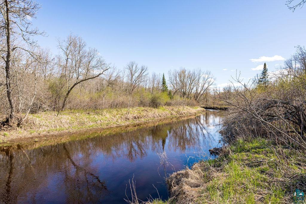 20663 Hardwood Loop Finlayson, MN 55735 - Photo 3 of 36 Natural waterway bordered by varied foliage and clear sky