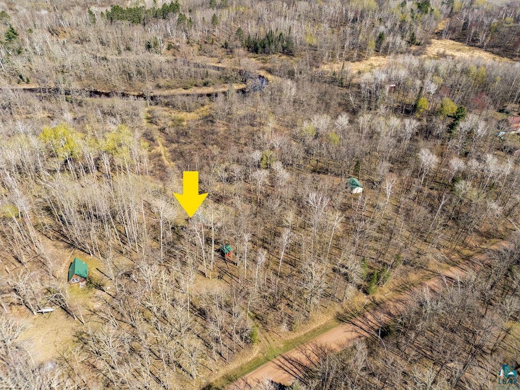 20663 Hardwood Loop Finlayson, MN 55735 - Photo 32 of 36 Wooded acreage featuring multiple structures, dense tree cover, and unpaved pathways