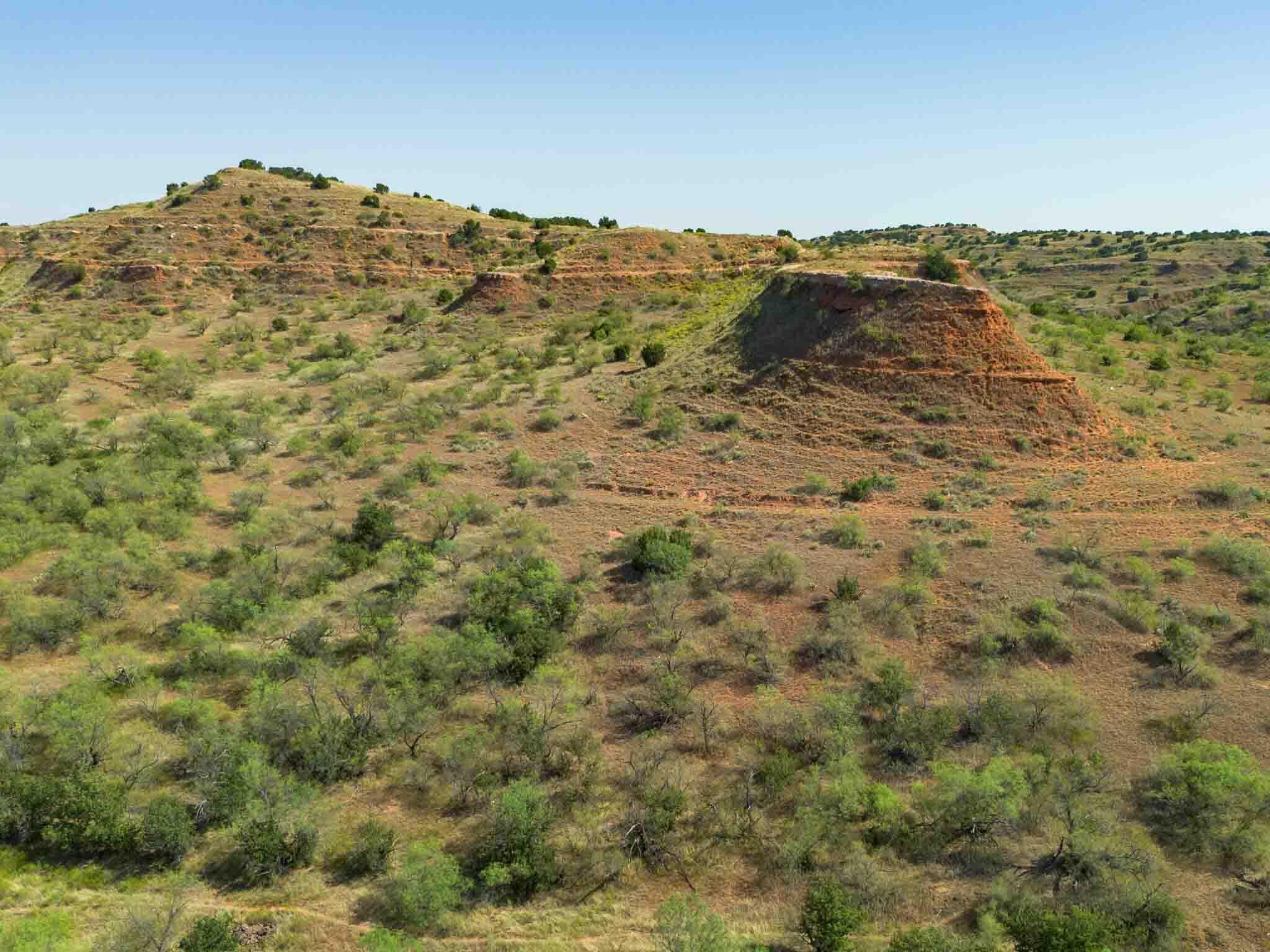 Reeves Ranch Memphis, TX 79245 - Photo 55 of 144 a view of a large building with mountains in the background