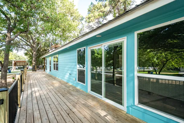 a kitchen with stainless steel appliances granite countertop a stove a refrigerator a sink dishwasher a dining table and chairs