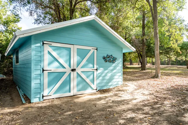 a view of a porch with wooden floor and wooden fence