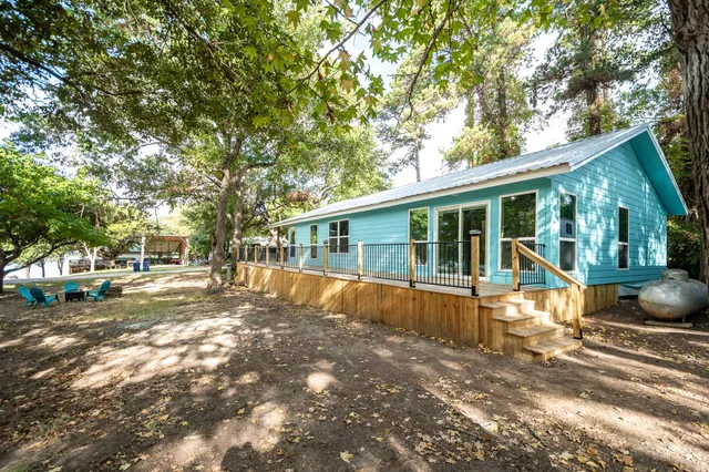 a kitchen with stainless steel appliances granite countertop a stove a refrigerator a sink dishwasher a dining table and chairs