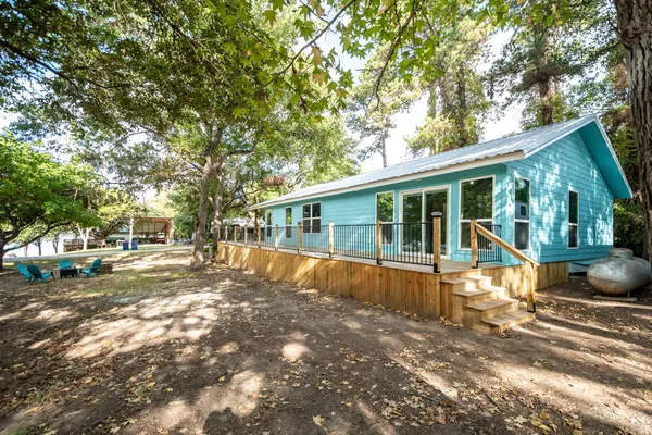 a dining room with furniture a chandelier and wooden floor