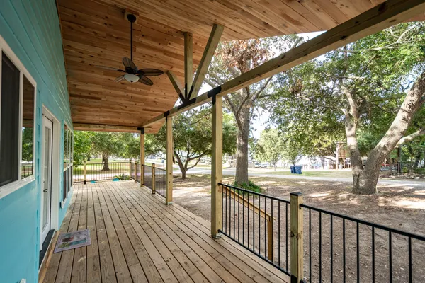 a kitchen with stainless steel appliances granite countertop a dining table chairs stove a refrigerator and cabinets