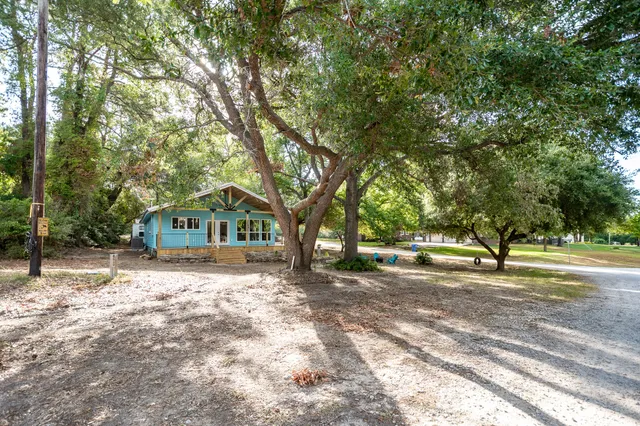 a view of a house with swimming pool and sitting area