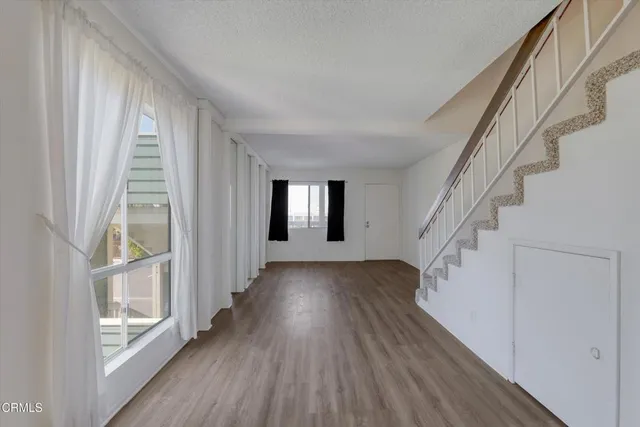 a view of entryway with wooden floor and front door