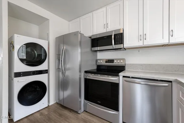 a kitchen with cabinets and stainless steel appliances