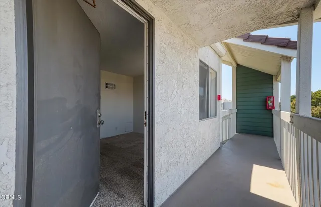 a view of a hallway with wooden shelves