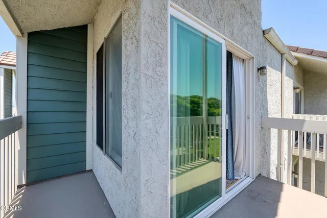 a view of a balcony with potted plants