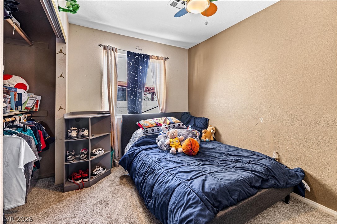 1624 Palmae Way Las Vegas, NV 89128 - Photo 11 of 18 This cozy bedroom offers a well-appointed closet and a window that provides natural illumination.