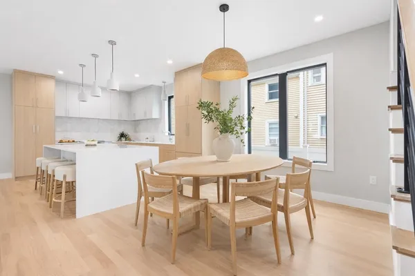 a view of a dining room with furniture window and wooden floor