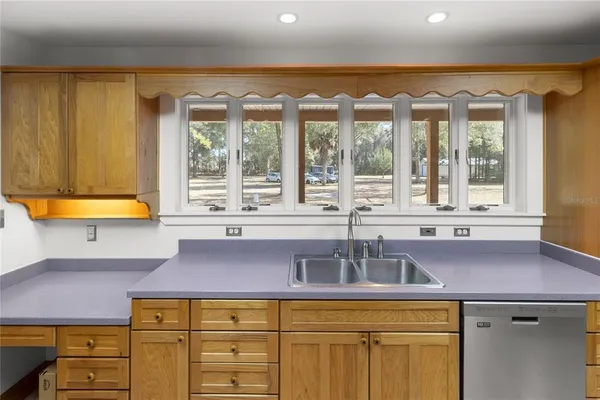 a bathroom with a granite countertop sink a toilet and shower