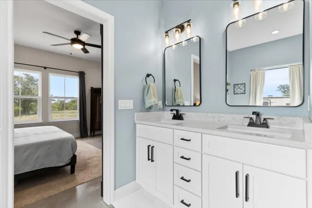 a en suite bathroom with double sink and a mirror