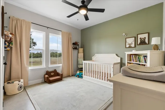 a bedroom with furniture and a large window