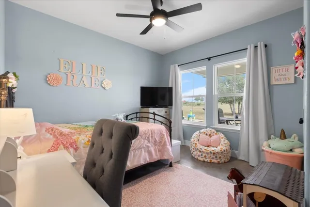 a bedroom with bed and a window