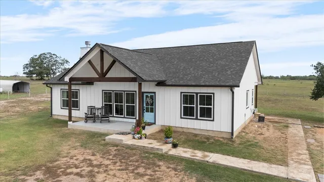 a front view of a house with a yard outdoor seating and barbeque oven