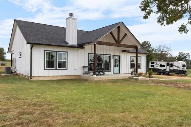 a front view of a house with swimming pool having outdoor seating
