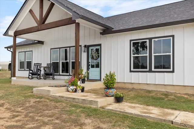a view of a house with sitting area and garden