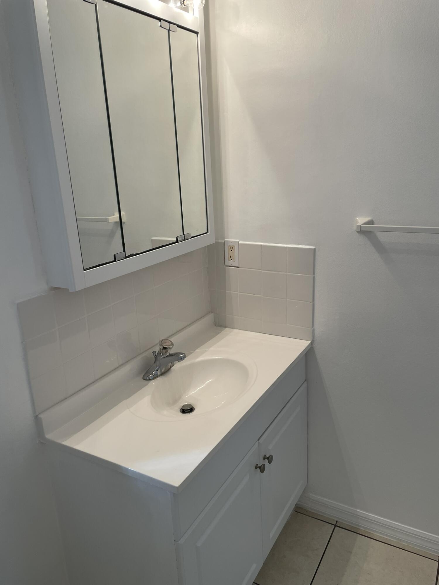 4448 Northwest Bighorn Avenue Port St. Lucie, FL 34983 - Photo 16 of 19 a bathroom with a sink and a mirror