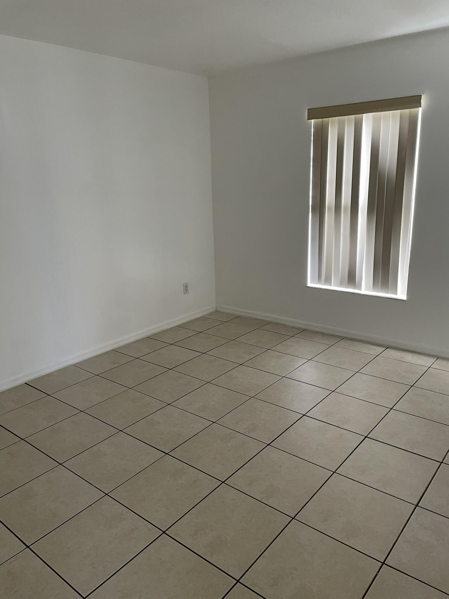 4448 Northwest Bighorn Avenue Port St. Lucie, FL 34983 - Photo 3 of 19 a view of an empty room and a window