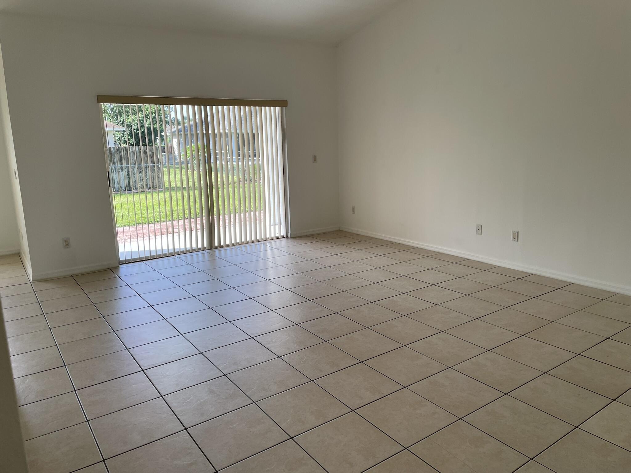 4448 Northwest Bighorn Avenue Port St. Lucie, FL 34983 - Photo 5 of 19 a view of an empty room and a window