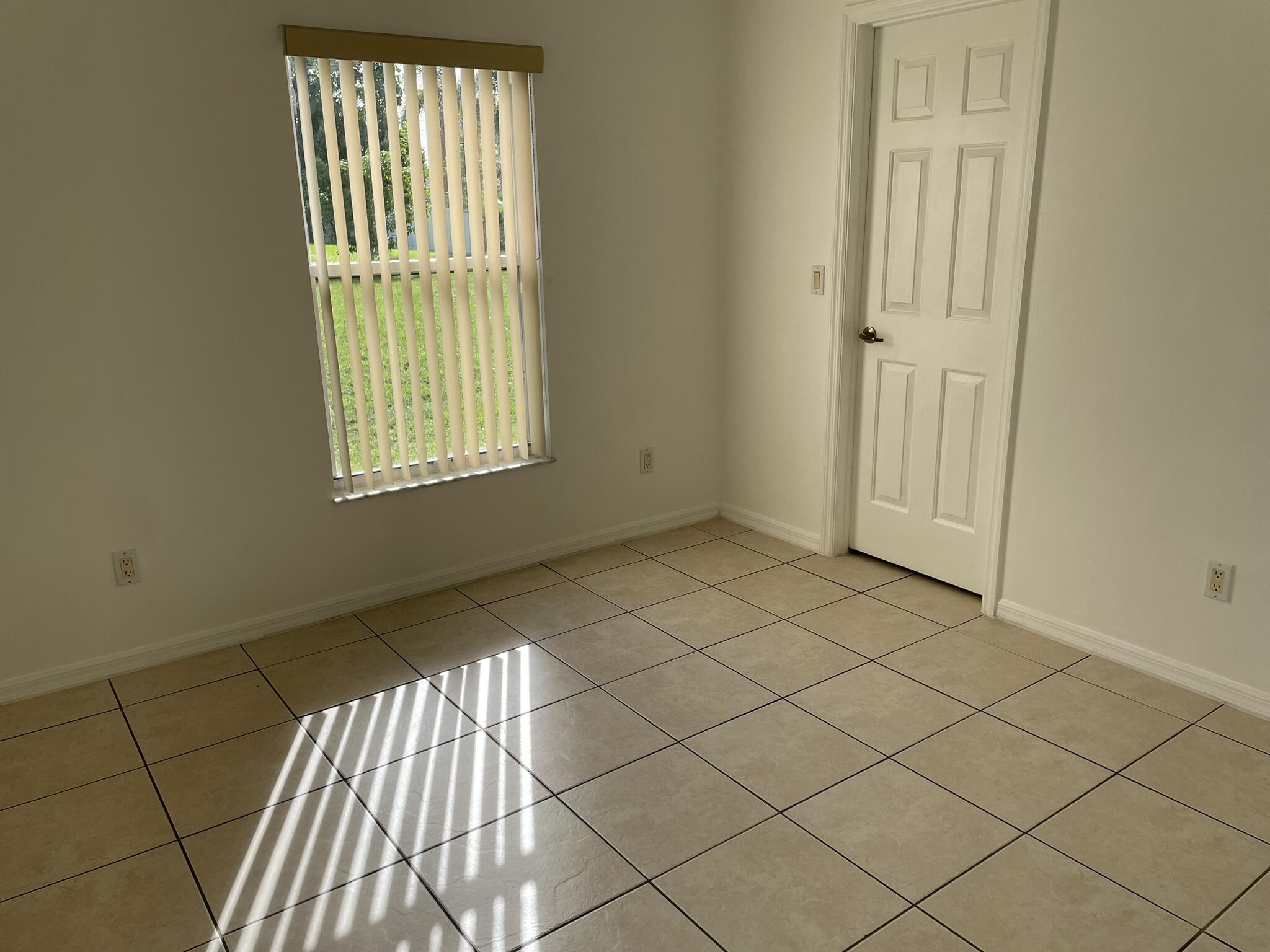 4448 Northwest Bighorn Avenue Port St. Lucie, FL 34983 - Photo 10 of 19 an empty room with windows
