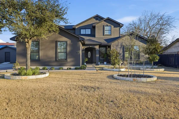 a front view of a house with garden