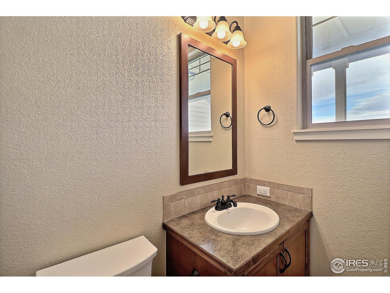 360 Bluegrass Street Eaton, CO 80615 - Photo 11 of 32 a bathroom with a sink and a mirror