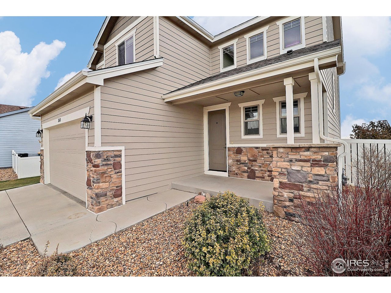 360 Bluegrass Street Eaton, CO 80615 - Photo 2 of 32 a front view of a house with a yard
