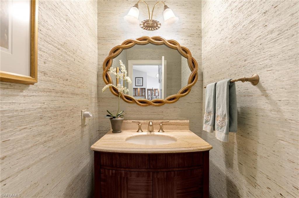 2209 Regal Way Naples, FL 34110 - Photo 19 of 24 a bathroom with a sink and a mirror