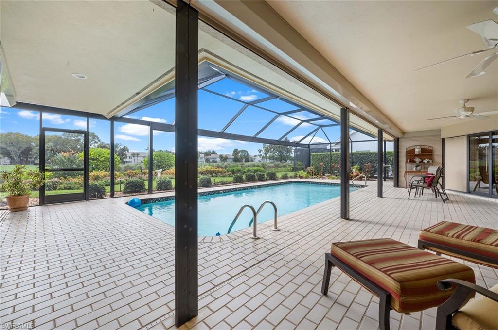 2209 Regal Way Naples, FL 34110 - Photo 2 of 24 a living room with furniture and a floor to ceiling window