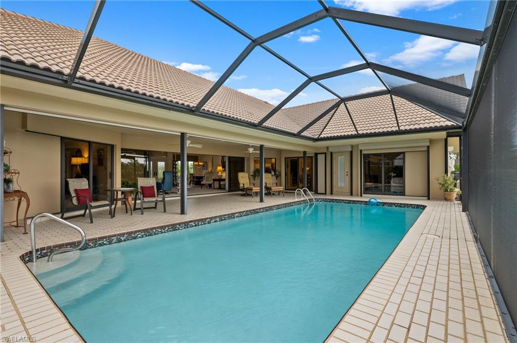 2209 Regal Way Naples, FL 34110 - Photo 22 of 24 a view of a house with pool and sitting area