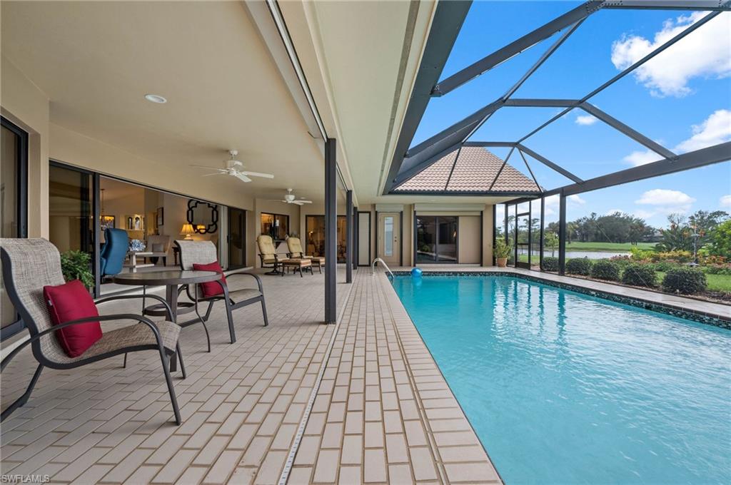 2209 Regal Way Naples, FL 34110 - Photo 3 of 24 a view of swimming pool with seating area and furniture