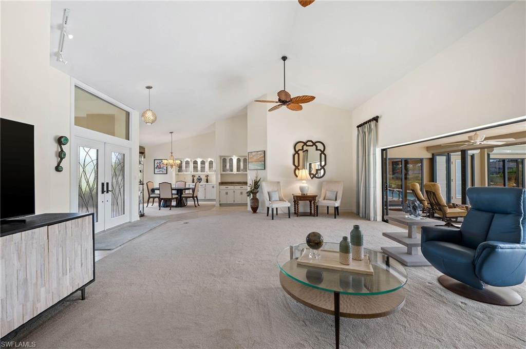 2209 Regal Way Naples, FL 34110 - Photo 7 of 24 a living room with furniture and a flat screen tv