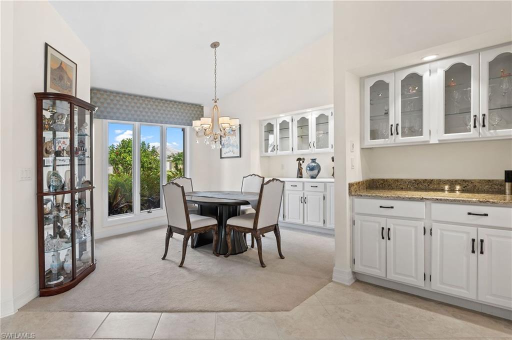 2209 Regal Way Naples, FL 34110 - Photo 8 of 24 a view of a dining room with furniture window and wooden floor