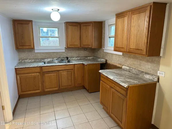 a kitchen with a stove sink and cabinets