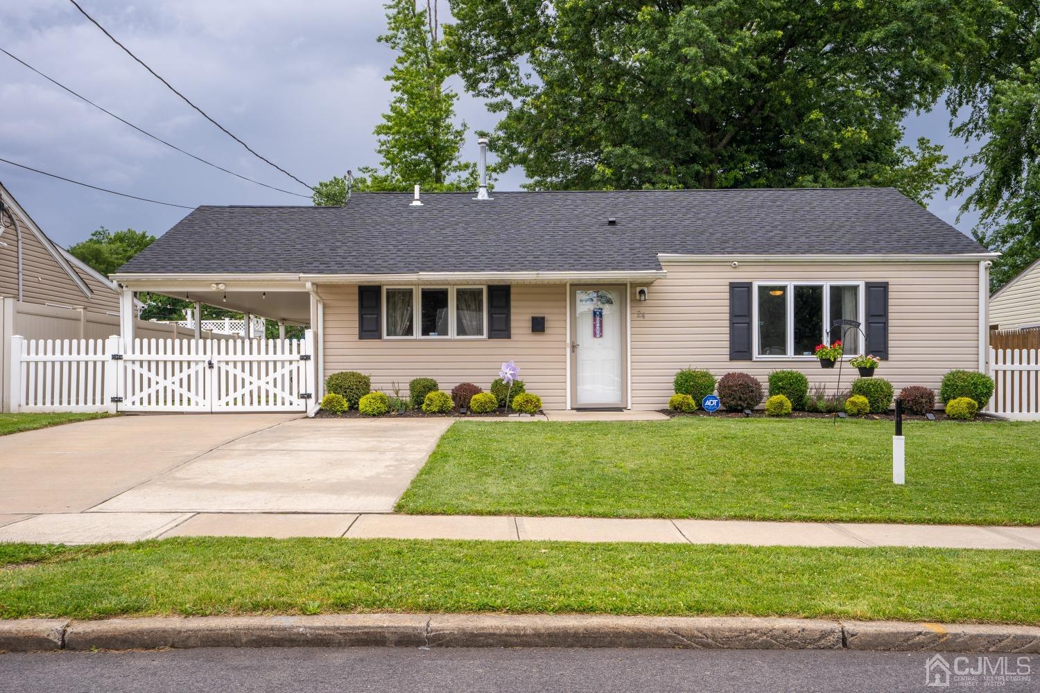 24 Kenmore Road Edison, NJ 08817 - Photo 1 of 21 a front view of a house with a yard and garage