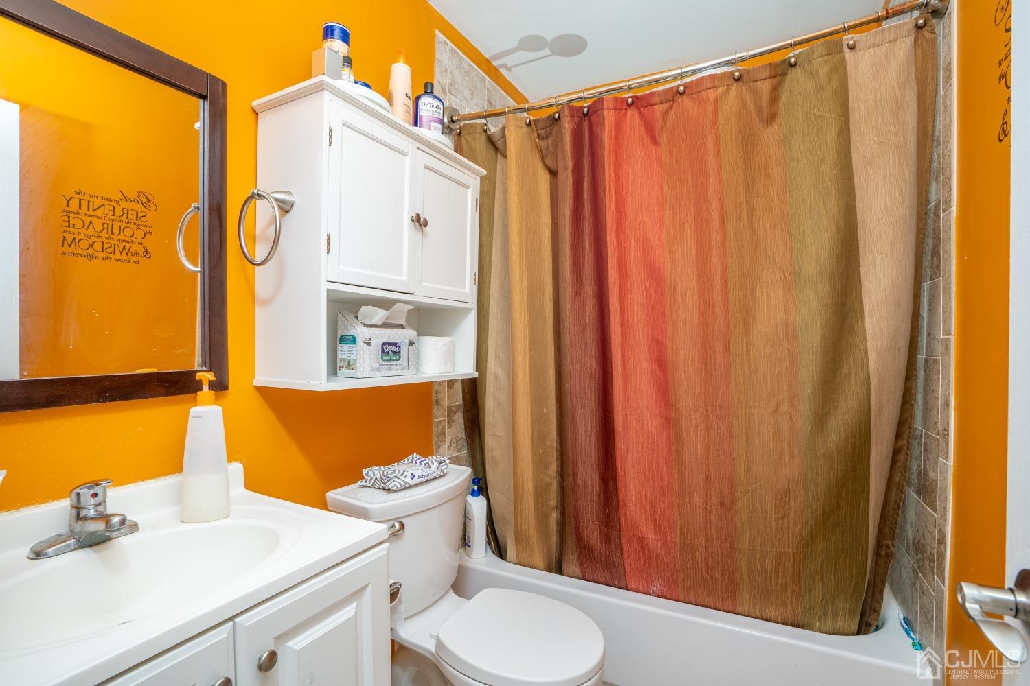 24 Kenmore Road Edison, NJ 08817 - Photo 13 of 21 a bathroom with a sink a toilet and shower curtain