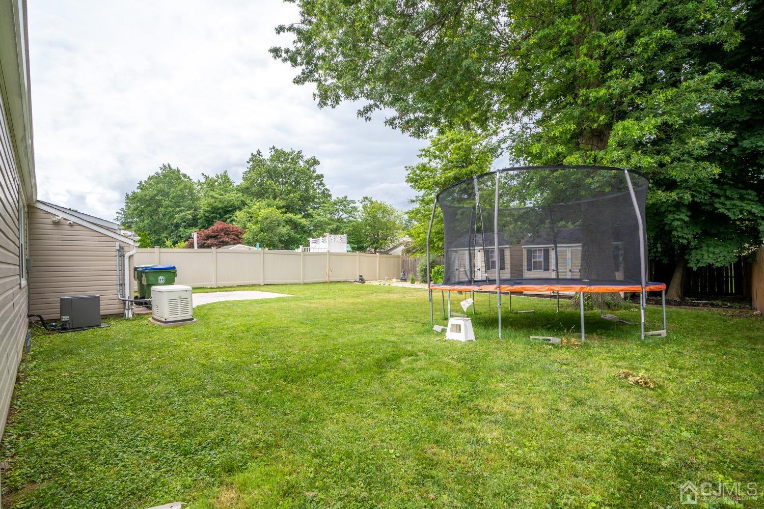 24 Kenmore Road Edison, NJ 08817 - Photo 21 of 21 a backyard with a garden and swing